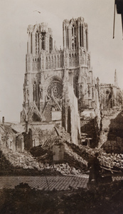 View of a cathedral with damaged sections in foreground, Reims