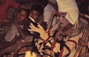 Performer of the Rangda character pulls on his claws