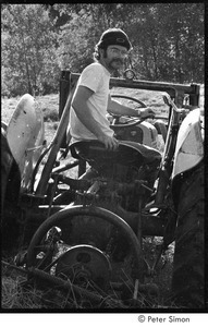 Man (possibly Michael Gies) on tractor, Packer Corners commune