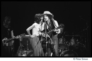 Joan Baez with arm on the shoulder of Bob Dylan, performing with the Rolling Thunder Revue at the Harvard Square Theater