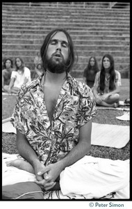 Man in deep meditation during Ram Dass's appearance at Andrews Amphitheater, University of Hawaii