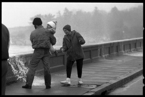 Judy Salonia, her husband Vincent, and daughter Ashley (4) dodge the spray at the Narragansett seawall