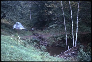 Tent made of plastic sheeting by the side of a stream, Johnson Pasture Commune