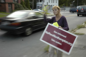 Protest against a pornographic video store in Northampton: protester handing out fliers to cars on North Street