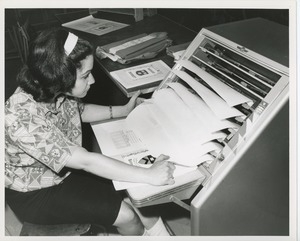 Woman assembling books