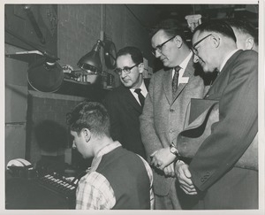 Attendees observe an ICD client at work at the 1959 Rehabilitation Counselors Conference