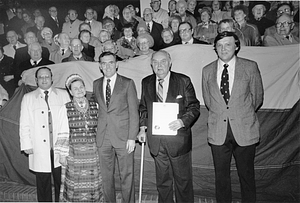 Mayor Raymond L. Flynn posing with City Councilor James M. Kelly, Elderly Affairs Commissioner Michael Taylor and a large group of unidentified people