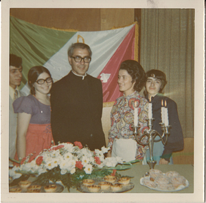 Maria de Lourdes Serpa (second from right), with group, in front of Youth Group flag