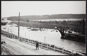 Two dredgers dig on the Cape Cod Canal in Bournedale, Mass