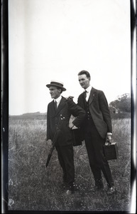 Unidentified men with cameras and tripod