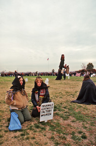 Two mourners on the lawn opposite the Pentagon