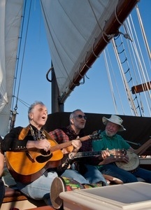 David Amram, Raffi, and Pete Seeger (from left) playing music aboard the Mystic Whaler, during the Clearwater Festival