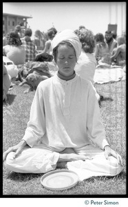Woman in a turban, meditating during Ram Dass's appearance at Sonoma State University