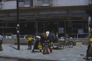 Gypsy woman passing store