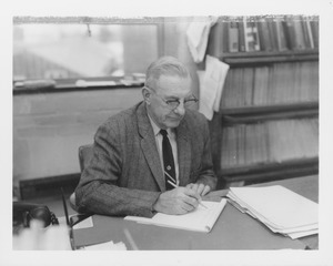 Warren D. Whitcomb seated at his desk in Matthew Field Station