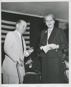 Unidentified woman handing gift to client at Institute Day