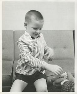 A young boy uses his new prosthetic hand