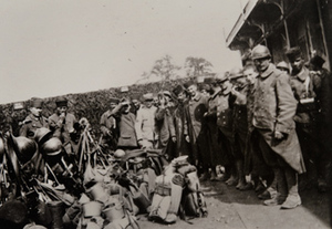 Group of soldiers with their kits, pose for a photo outside a canteen