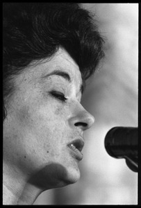 Unidentified woman: close-up portrait, speaking at a podium