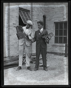 Jack Dixon (left) and unidentified colleague posed with their Graflex cameras