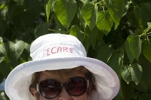 Pro-immigration protester wearing a sun hat with the words 'I care': taken at the 'Families Belong Together' protest against the Trump administration's immigration policies