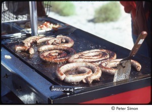 MUSE concert and rally: sausage cooking on a griddle