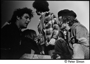 Abbie Hoffman (left) talking with other protesters