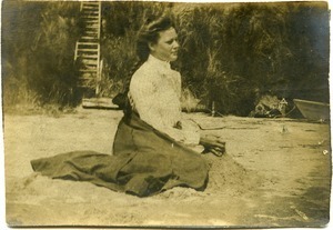 Alice Channing: portrait, seated on the sand