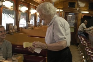 Waitress tending to customers at a booth, Miss Florence Diner