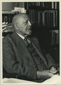 W. E. B. Du Bois sitting in his library