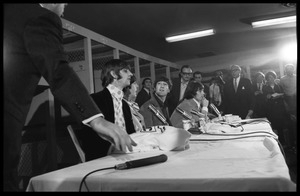 Ringo Starr, Paul McCartney, John Lennon, and George Harrison (l. to r.) seated at a table during a Beatles press conference