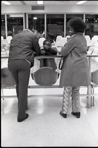 Couple and child waiting at JFK airport