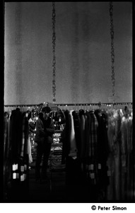 Stephen Davis standing amid clothes racks in Cyreld's boutique, Coolidge Corner