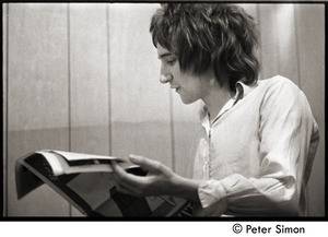 Rod Stewart reading a magazine