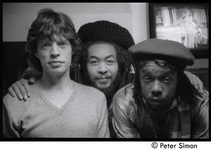 Mick Jagger, unidentified man, and Peter Tosh (l. to r.) backstage on Saturday Night Live: close-up portrait
