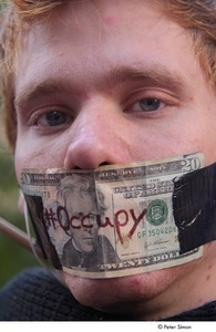 Occupy Wall Street: close-up of demonstrator with a twenty dollar bill taped over his mouth