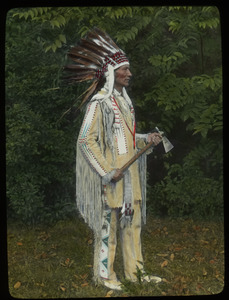 Charles A. Eastman (man in Native American clothing and headdress with hatchet, Ohiyesa)