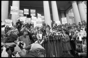 Gary Hart at a microphone-encrusted podium, addressing an crowd after renewing his bid for the Democratic nomination for the presidency