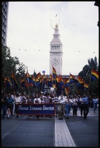 Marchers in the San Francisco Pride Parade with pride flags and banner 'Proud / Strong United 1987'