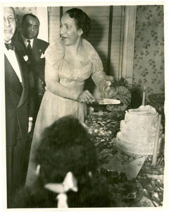 Shirley Graham Du Bois with W. E. B. Du Bois cutting cake at their wedding reception