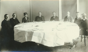 Faculty members gathered around dining table