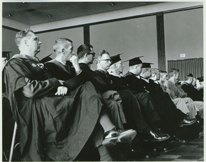 Unidentified faculty seated in crowd at the Centennial Honors Day convocation