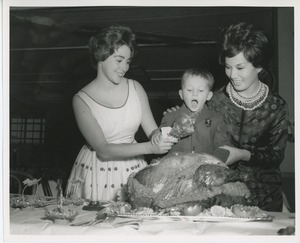 Young client and two women at Thanksgiving celebration