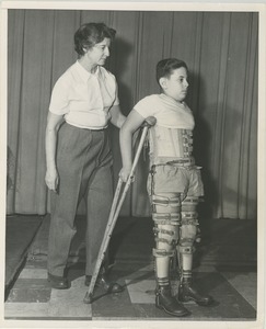 Arnold Goldman walking on crutches during physical rehabilitation