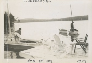 Unidentified men rolling up sails