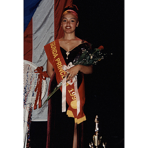 The second princess holds a bouquet of flowers at the Festival Puertorriqueño