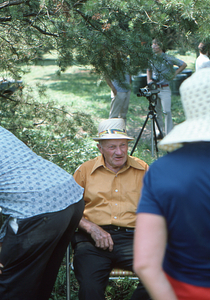 Harvey Cummings in lawn chair at the Moon Barn Raising at entrance to Hopkins Forest on 2 August 1975.