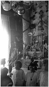 Children in front of home altar in Back Central Street neighborhood