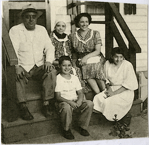 Naro family and Anna Souza Rose on cottage stairs