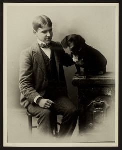 Three-quarter length portrait of Gardner Richardson, seated, facing front with his dog, location unknown